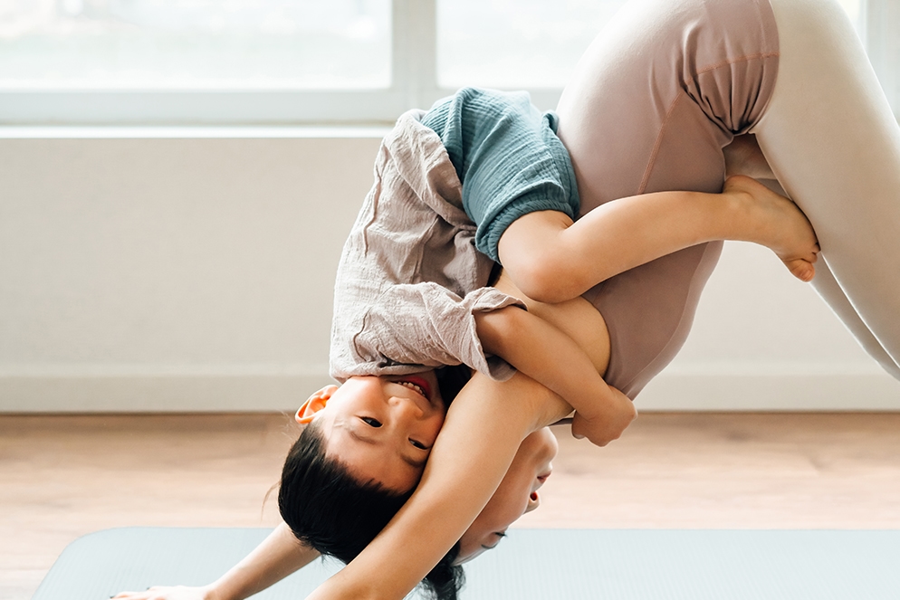 Woman doing yoga with child