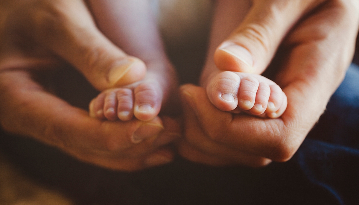 Baby feet in parent's hands