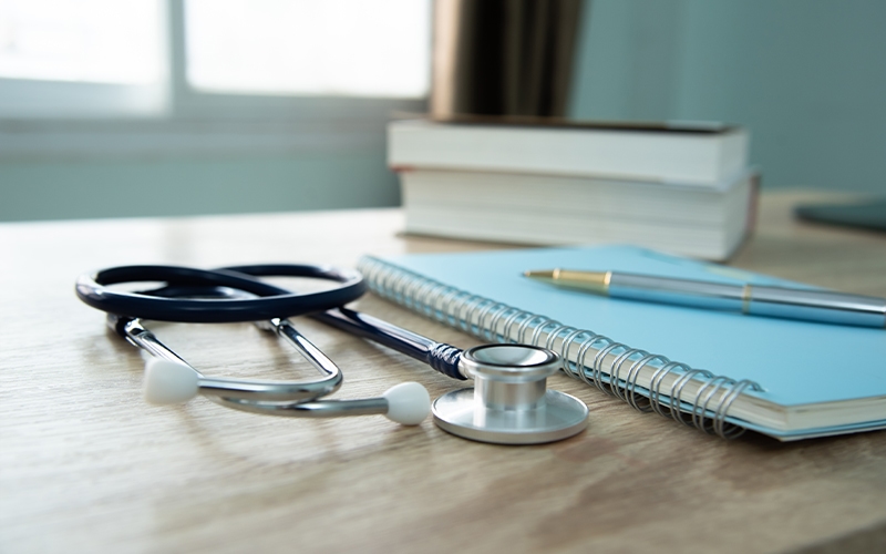 stethoscope on table with books