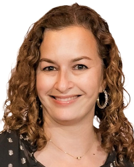 woman with curly hairs hoop earrings and black blouse