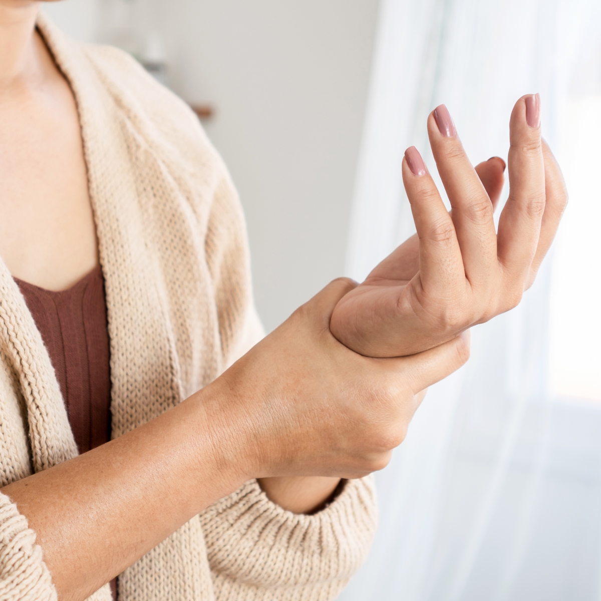 woman holding her wrist