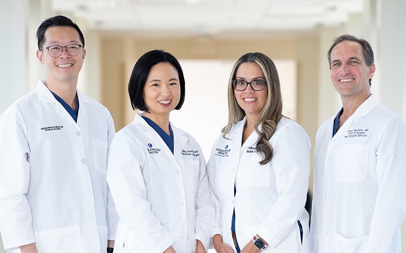 four surgeons posing for camera